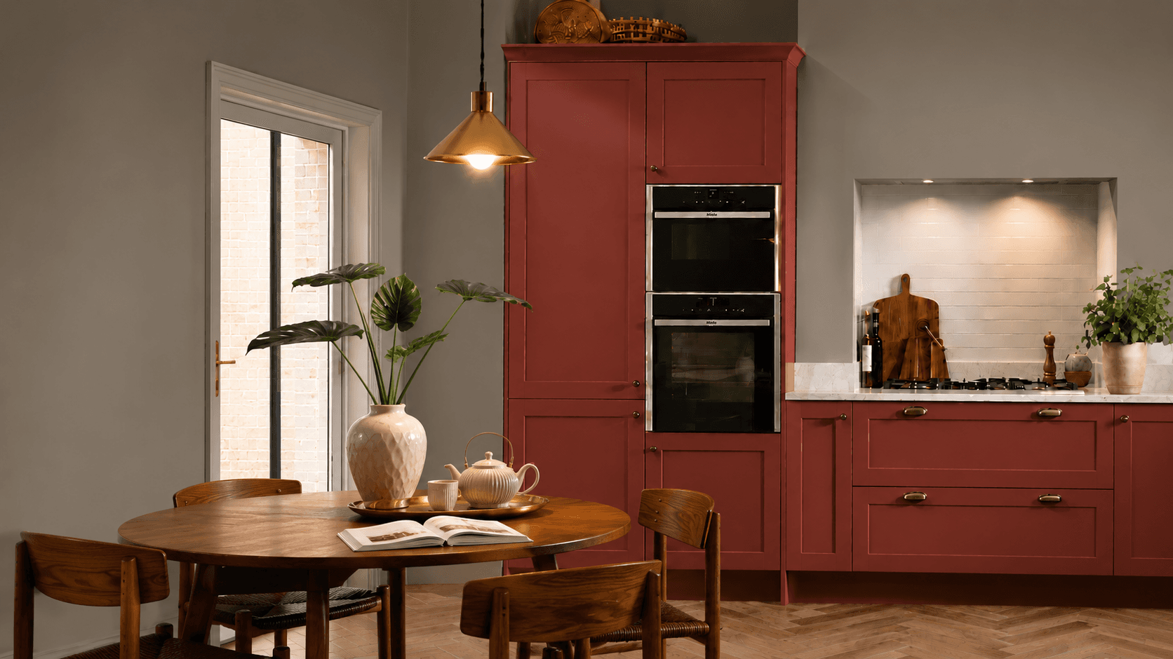Terracotta red fitted kitchen with replacement doors by The Cabinet Door Shop in Hove